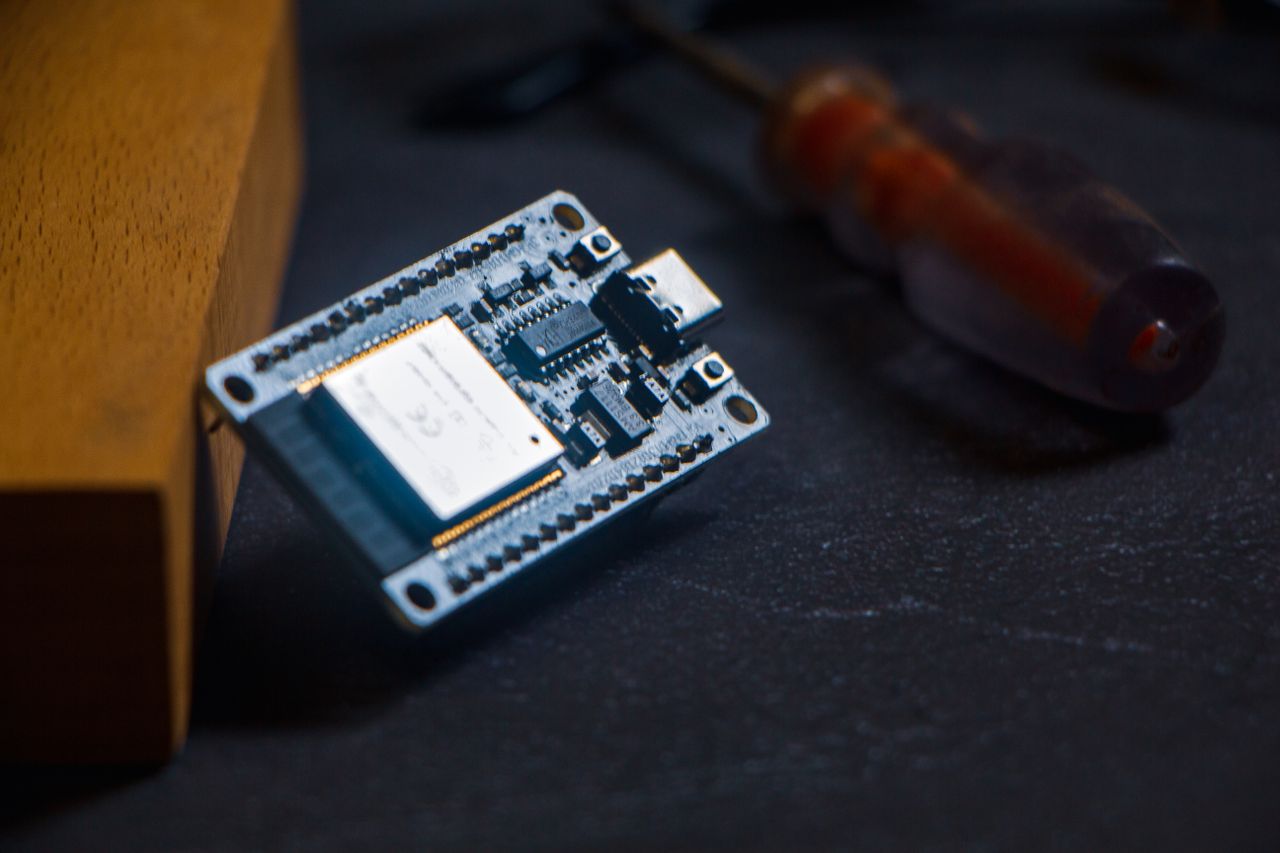 about-us-02 Microcontroller chip with screwdriver on dark surface, ideal for tech and innovation themes.